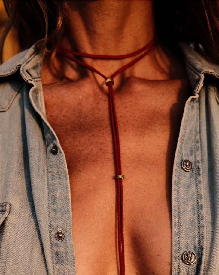 Un lien Carmin en cuir vegan, rehaussé de perles en acier inoxydable. Brûlant, affirmé, hypnotique.